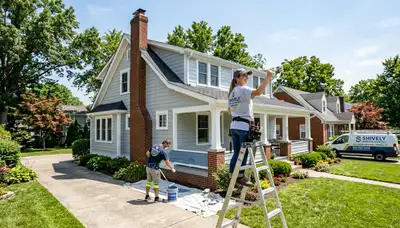 Professional house painters in Louisville KY finishing exterior siding with premium paint